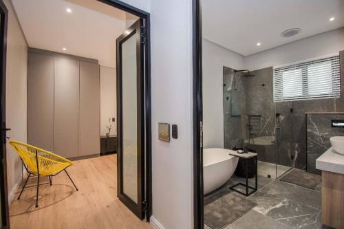 un bagno con vasca, lavandino e vasca da bagno di Modern House Dalsig Stellenbosch a Stellenbosch