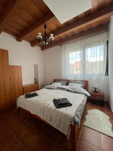 a bedroom with a large bed in a room at Véneki-pihi Vendégház in Vének