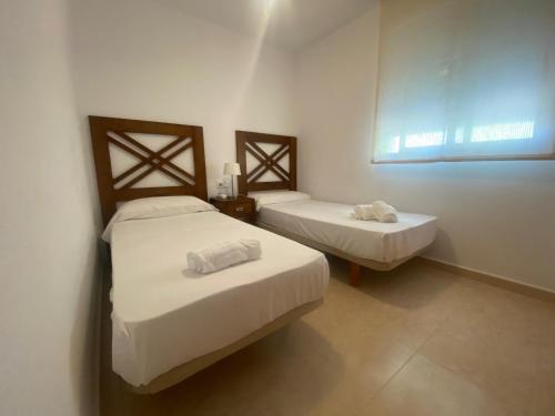 A bed or beds in a room at Delfines III Solo Familias Serviplaya