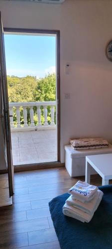 a room with a view of a balcony with a table at Sara in Nîmes