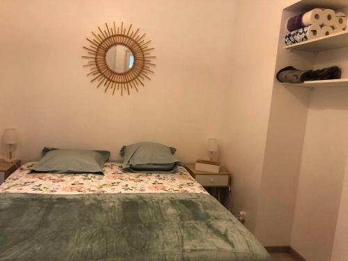 a bedroom with a bed and a mirror on the wall at Montbard appartements au centre historique chez Delphine et Guillaume in Montbard
