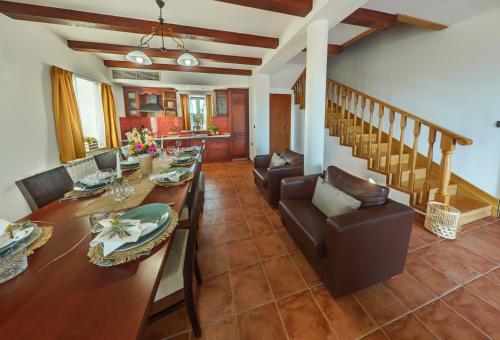 a dining room with a long table and chairs at Villa Primorje in Biograd na Moru