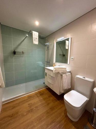 a bathroom with a shower and a toilet and a sink at Lagoa Beach & Leisure in Costa de Santo André
