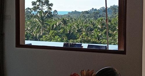 a room with a window with a view of a forest at Villa E in Taling Ngam Beach