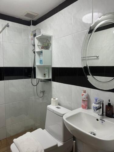 a bathroom with a white toilet and a sink at City Center Thai Villa 3 Bed room 2 Bath in Pattaya Central