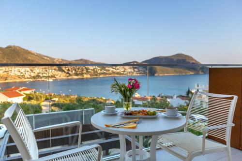 a table with a plate of food on a balcony at Rhapsody Hotel & Spa Kalkan in Kalkan