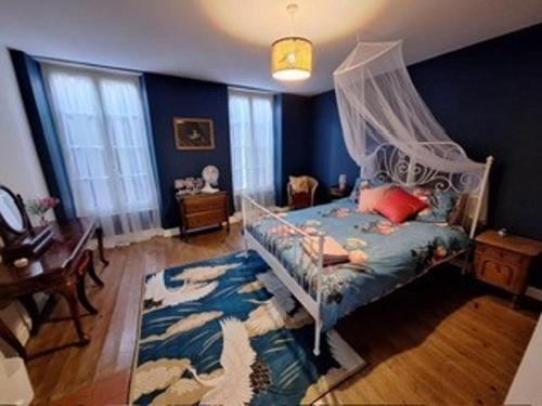 a bedroom with a bed with a canopy at Charming Countryside House in Beauvais with pool in Beauvais-sur-Matha