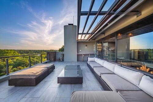 a living room with a couch and a table on a balcony at Elephant Point in Skukuza