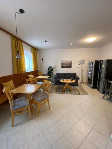 a living room with a table and chairs and a couch at Waldboden in San Leonardo in Passiria