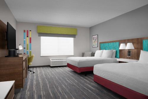 a hotel room with two beds and a window at Hampton Inn & Suites Durham North I-85 in Durham