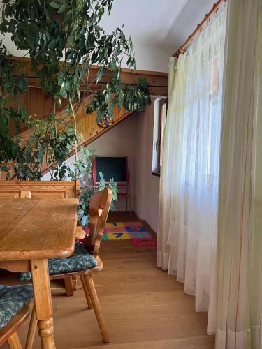 a dining room with a table and a curtain at Biohof Gölly in Neumarkt in Steiermark