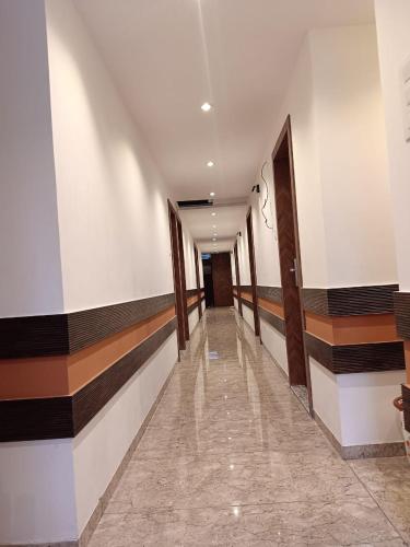 a hallway of a building with stripes on the walls at Hotel Metro Inn in Mumbai
