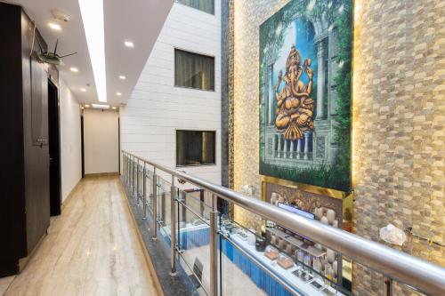 a hallway in a building with paintings on the wall at Hotel Gold Souk - Karol Bagh in New Delhi