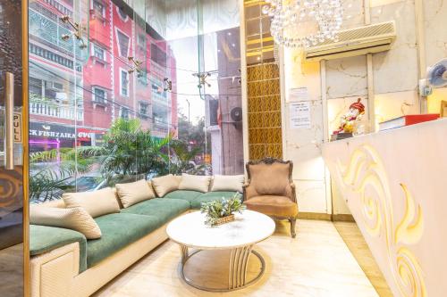 a living room with a couch and a table at Hotel Gold Souk - Karol Bagh in New Delhi