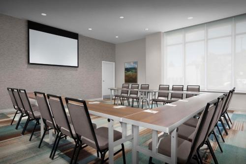a conference room with a long table and chairs at Home2 Suites by Hilton Eugene Downtown University Area in Eugene