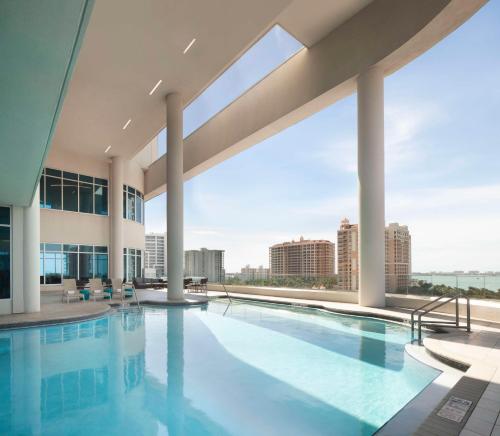 a swimming pool with a view of a building at Embassy Suites By Hilton Sarasota in Sarasota