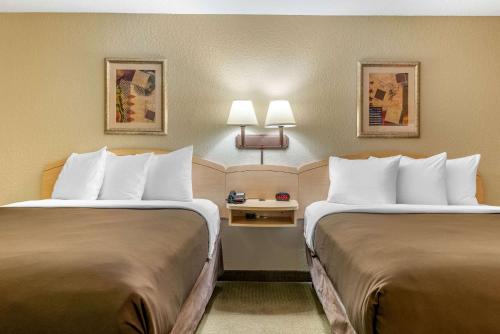 a hotel room with two beds in a room at Birch Hill Suites - South Bend in South Bend