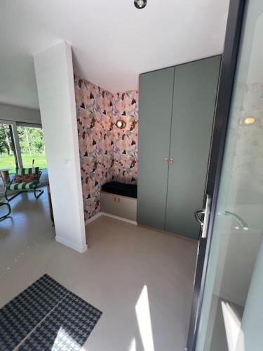 a living room with a sliding glass door with a couch at Au refuge de la colline Ecolodge 4 étoiles avec vue magnifique sur la vallée, proche de Mers les bains in Longroy