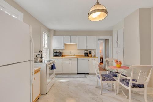 a kitchen with white cabinets and a table and chairs at Charming New England Home in West Hartford Center in West Hartford