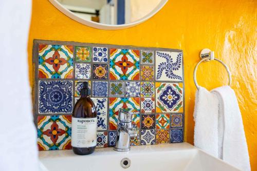 a bathroom with a bottle of wine on a sink at Starry Starry Night - Route 62 in Montagu