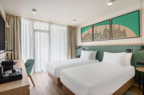 Кровать или кровати в номере Hilton Garden Inn Debrecen City Center
