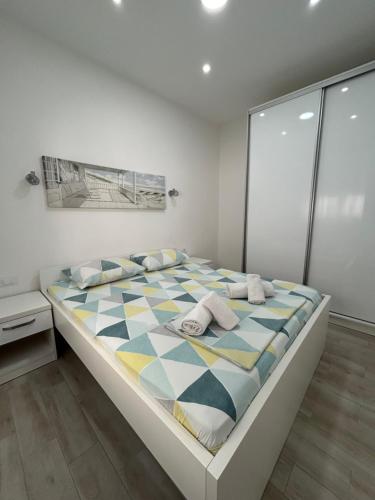a bedroom with a large bed with a checkered floor at Makera in Tivat