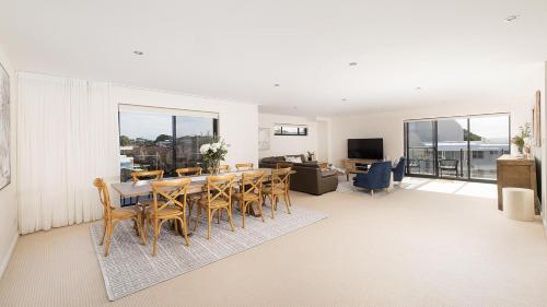 a dining room with a table and chairs at Bay Vista Penthouse - Heart of Nelson Bay in Nelson Bay