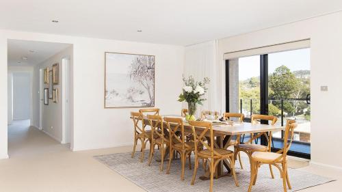 a dining room with a table and chairs at Bay Vista Penthouse - Heart of Nelson Bay in Nelson Bay