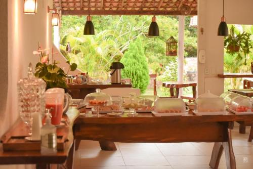 a dining room with a table with food on it at Bosque do Lapão in Lençóis