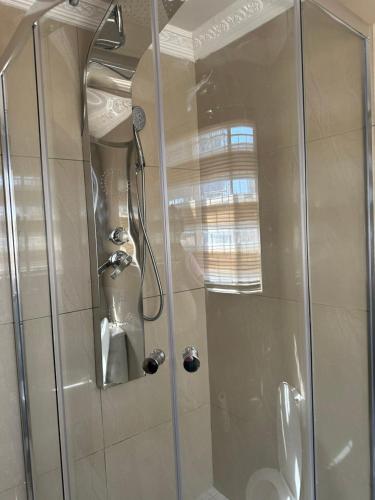 a shower with a glass door in a bathroom at Jobak Farm House in Bela-Bela
