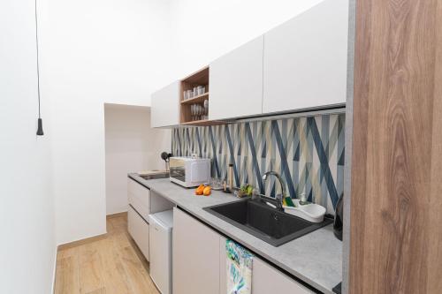 a kitchen with a sink and a counter top at Toto e Peppino Luxury Rooms in Naples