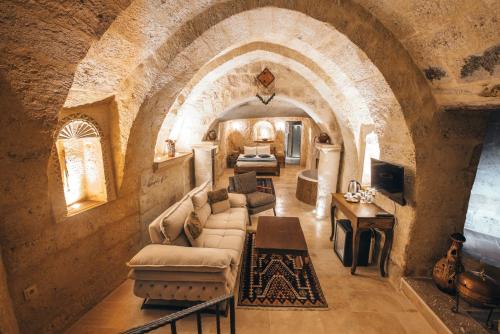 a living room with a couch and a table at Lagania In Cave in Urgup