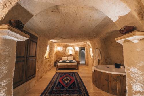 a bedroom with a bed and a bath tub at Lagania In Cave in Urgup