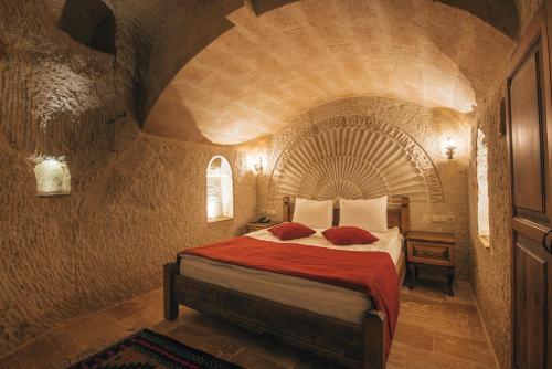 a bedroom with a bed in a stone room at Lagania In Cave in Urgup