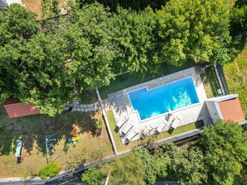 an overhead view of a swimming pool in a yard at House Runjic with pool, large garden and playground in Prgomet