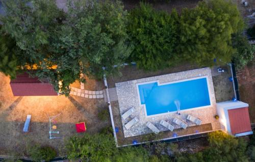 an overhead view of a swimming pool in a backyard at House Runjic with pool, large garden and playground in Prgomet