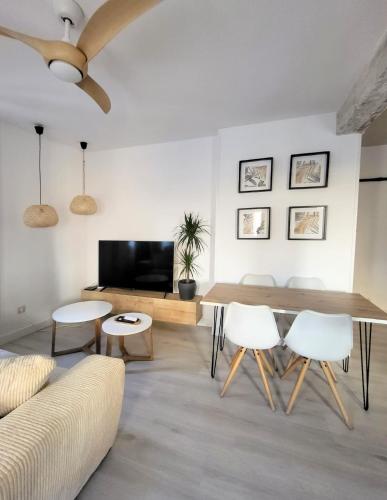 a living room with a couch and a table and chairs at Apartamentos Crispín Candela in Corella