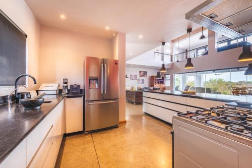 a large kitchen with a stainless steel refrigerator at Elephant Point in Skukuza