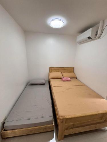 a small room with two bunk beds in it at Kataluma Inn in El Nido