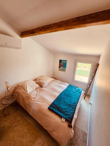 une chambre avec un lit dans une pièce avec une fenêtre dans l'établissement Maison avec piscine privative près de la mer, à La Londe-les-Maures