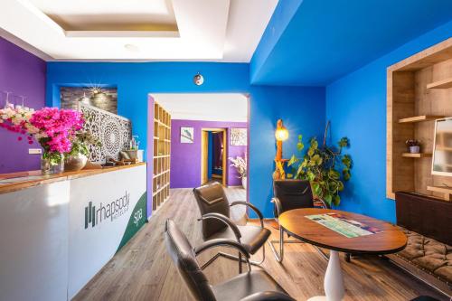 a room with blue walls and a table and chairs at Rhapsody Hotel & Spa Kalkan in Kalkan