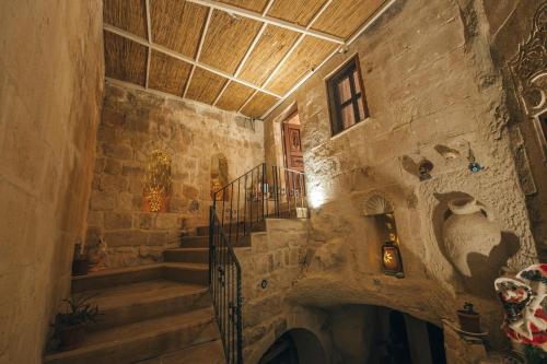 a staircase in a building with a stone wall at Lagania In Cave in Urgup