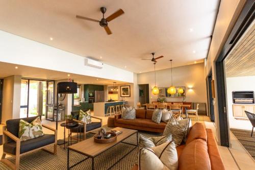 a living room with a couch and a table at Elephant Point in Skukuza