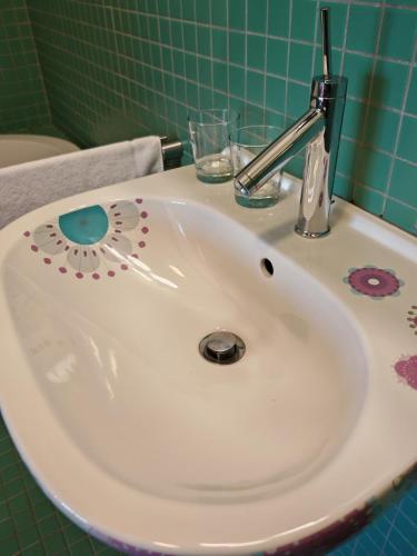 a white bathroom sink with a faucet on it at Hotel Rajská zahrada in Nové Město nad Metují
