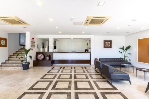a living room with couches and a staircase at Rhapsody Hotel & Spa Kalkan in Kalkan
