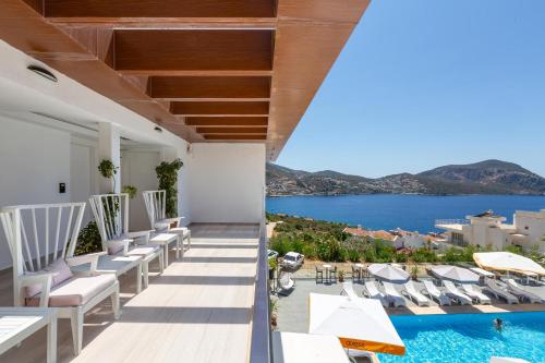 a view from the balcony of a hotel with chairs and a pool at Rhapsody Hotel & Spa Kalkan in Kalkan