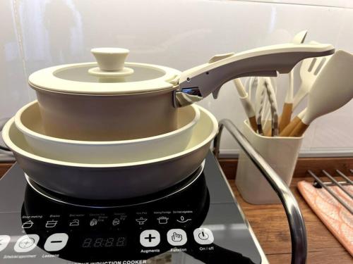 a stack of dishes sitting on top of a mixer at Horizon Ipoh 8Pax 3R2B - Tropical Bali Retreat in Ipoh