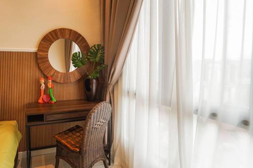 a bedroom with a table and a mirror and a chair at Horizon Ipoh 8Pax 3R2B - Tropical Bali Retreat in Ipoh