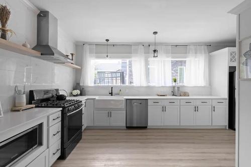 a kitchen with white cabinets and a stove at Atlanta's Secret Getaway in Atlanta