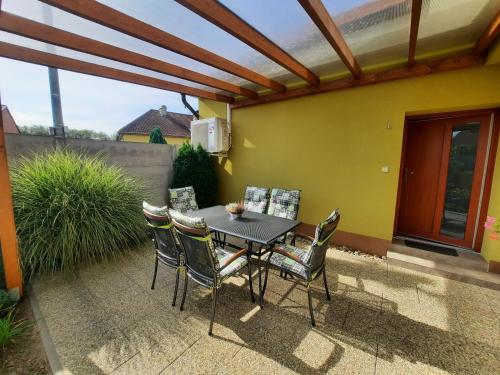 a patio with a table and chairs on a patio at Penzion Kateřina in Mikulčice